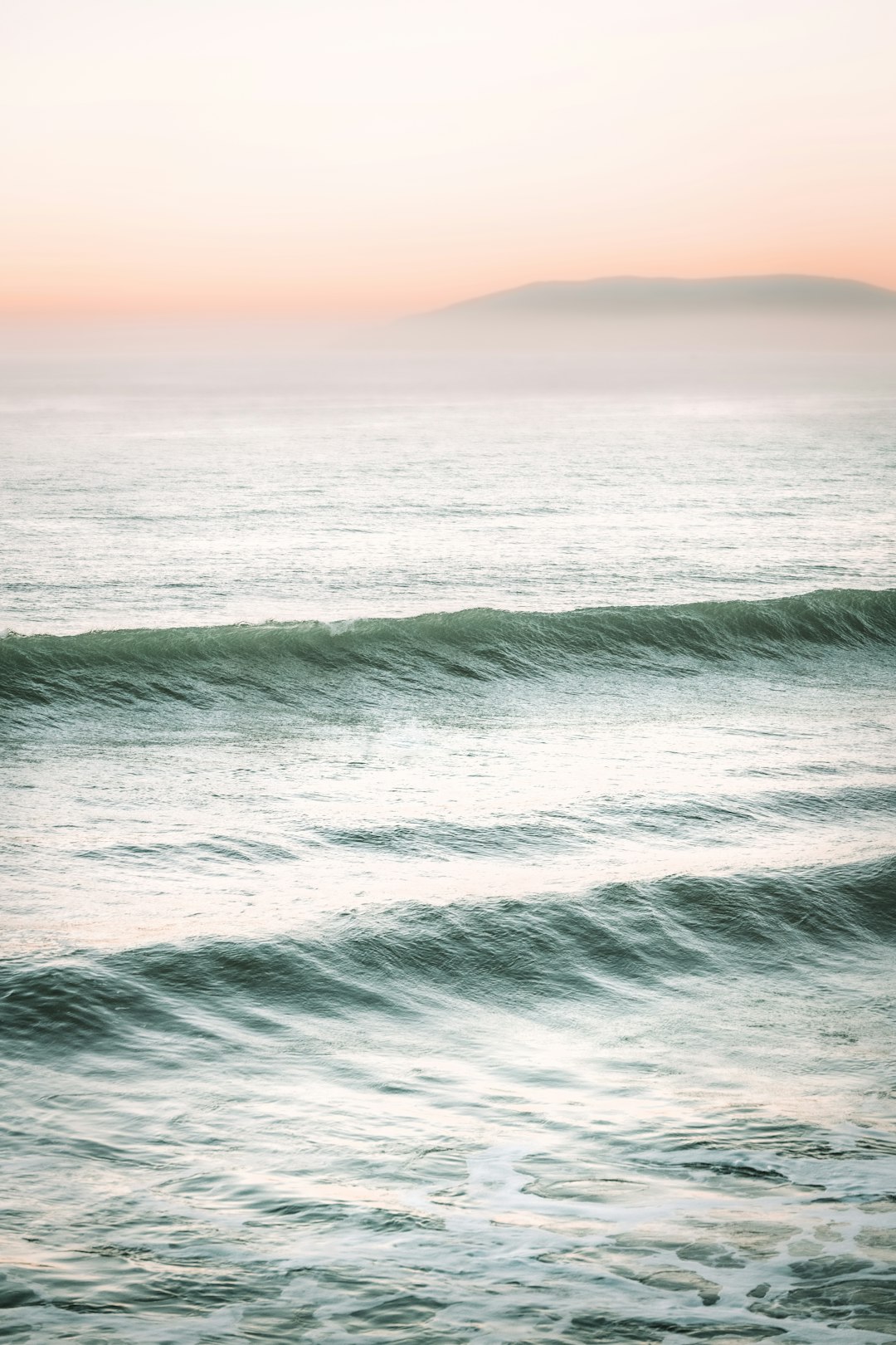 ocean waves under blue sky during daytime