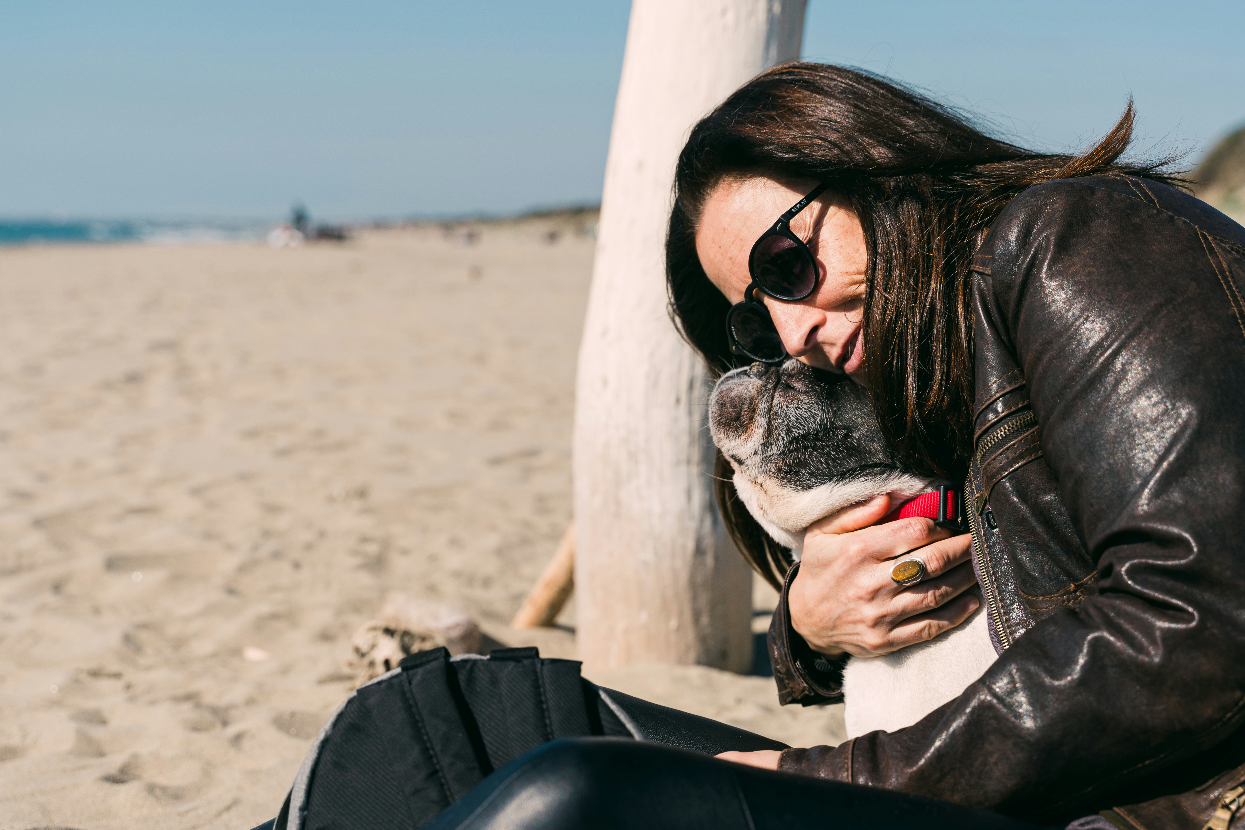 woman in black sunglasses and gray cardigan sitting on black chair