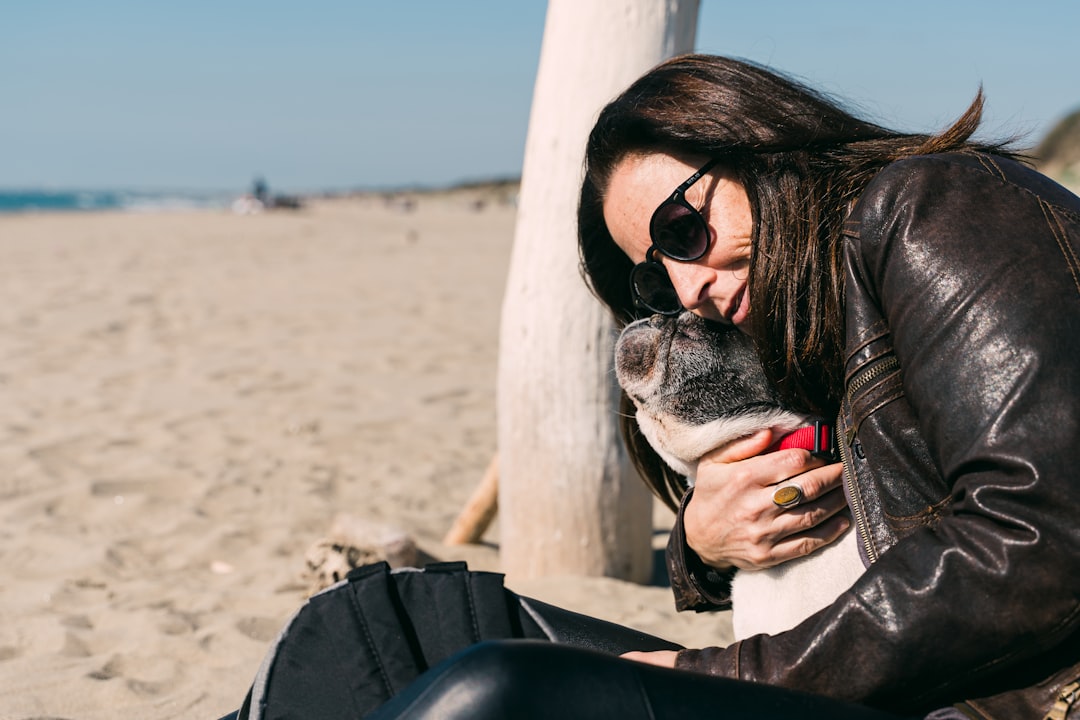 woman in black sunglasses and gray cardigan sitting on black chair