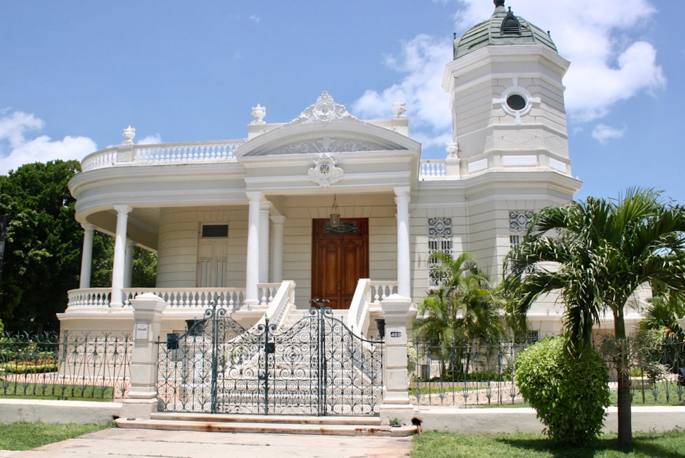 white concrete building with white metal fence