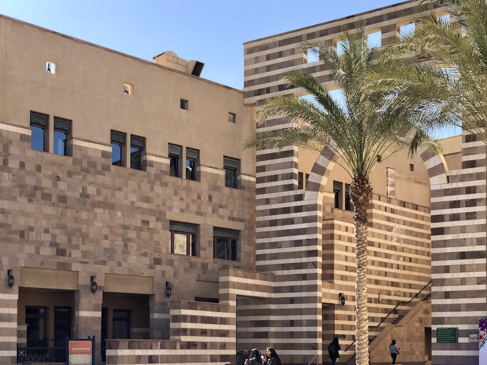 people walking near brown concrete building during daytime