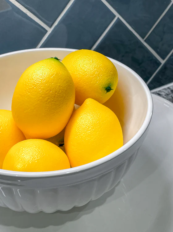 Fresh lemons in a bowl for food acidity applications