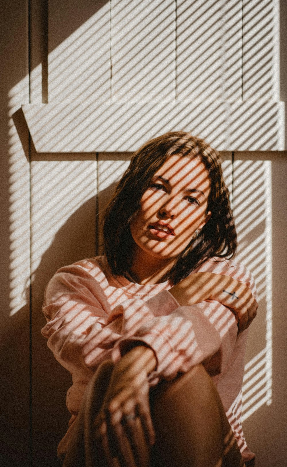 woman in white and pink stripe long sleeve shirt