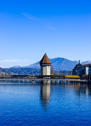 brown and white concrete building near body of water during daytime