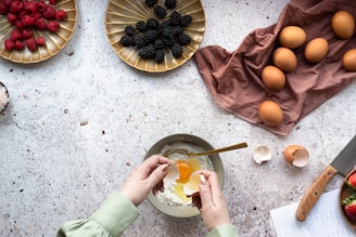 person holding stainless steel spoon with sliced orange fruit