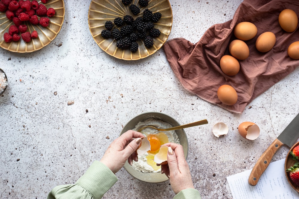 Persona che tiene il cucchiaio dell'acciaio inossidabile con la frutta dell'arancia affettata