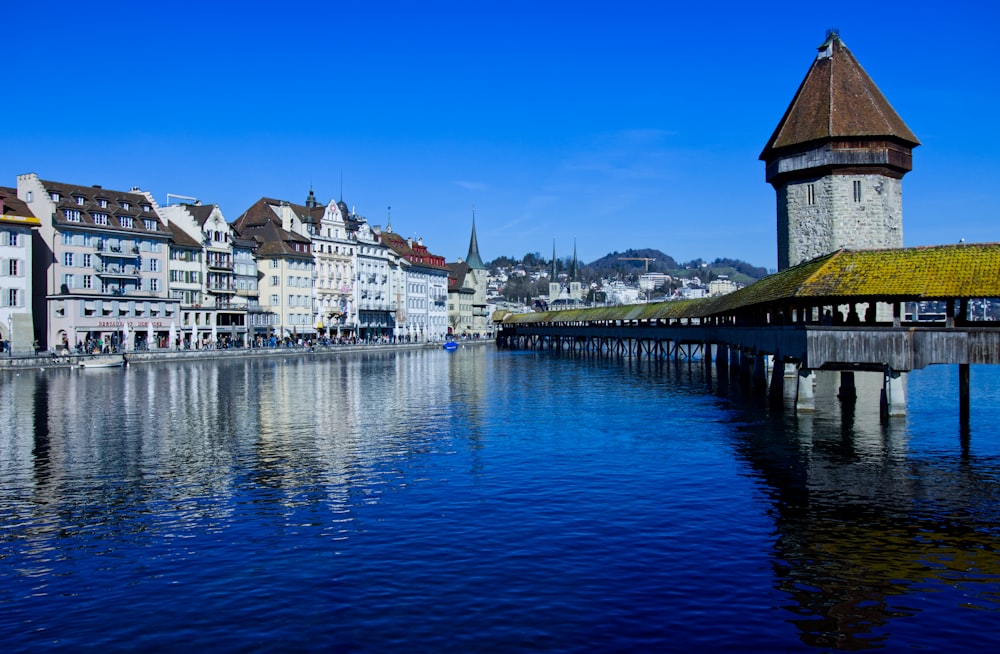 white and brown houses beside body of water during daytime