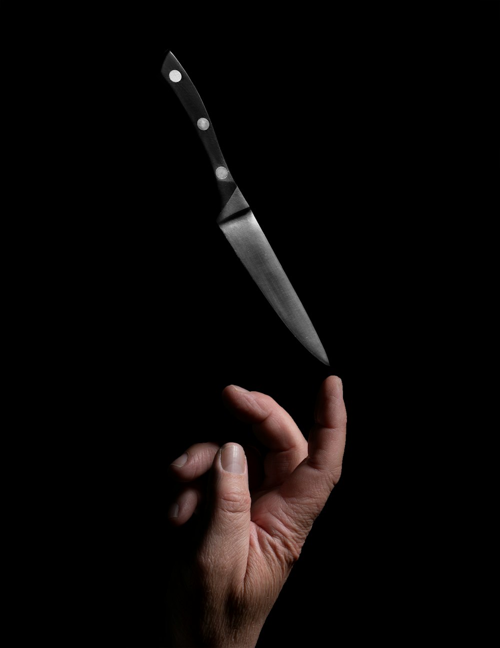 person holding stainless steel bread knife