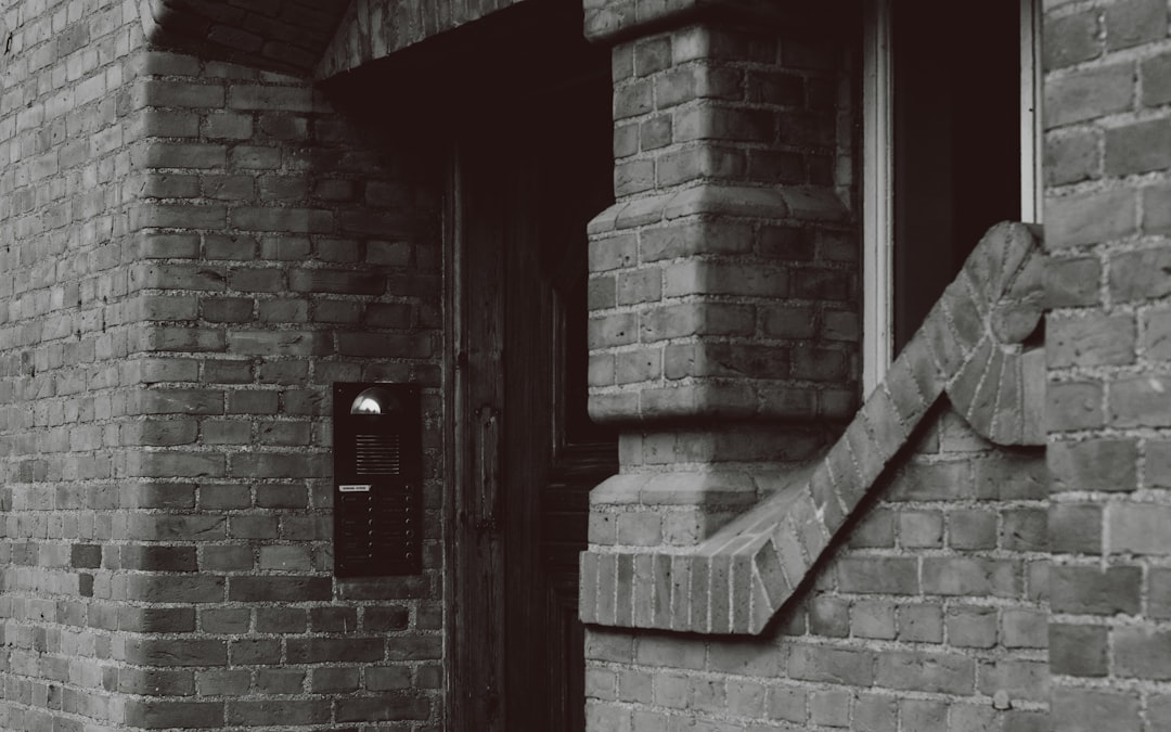 red wooden door on brown brick wall