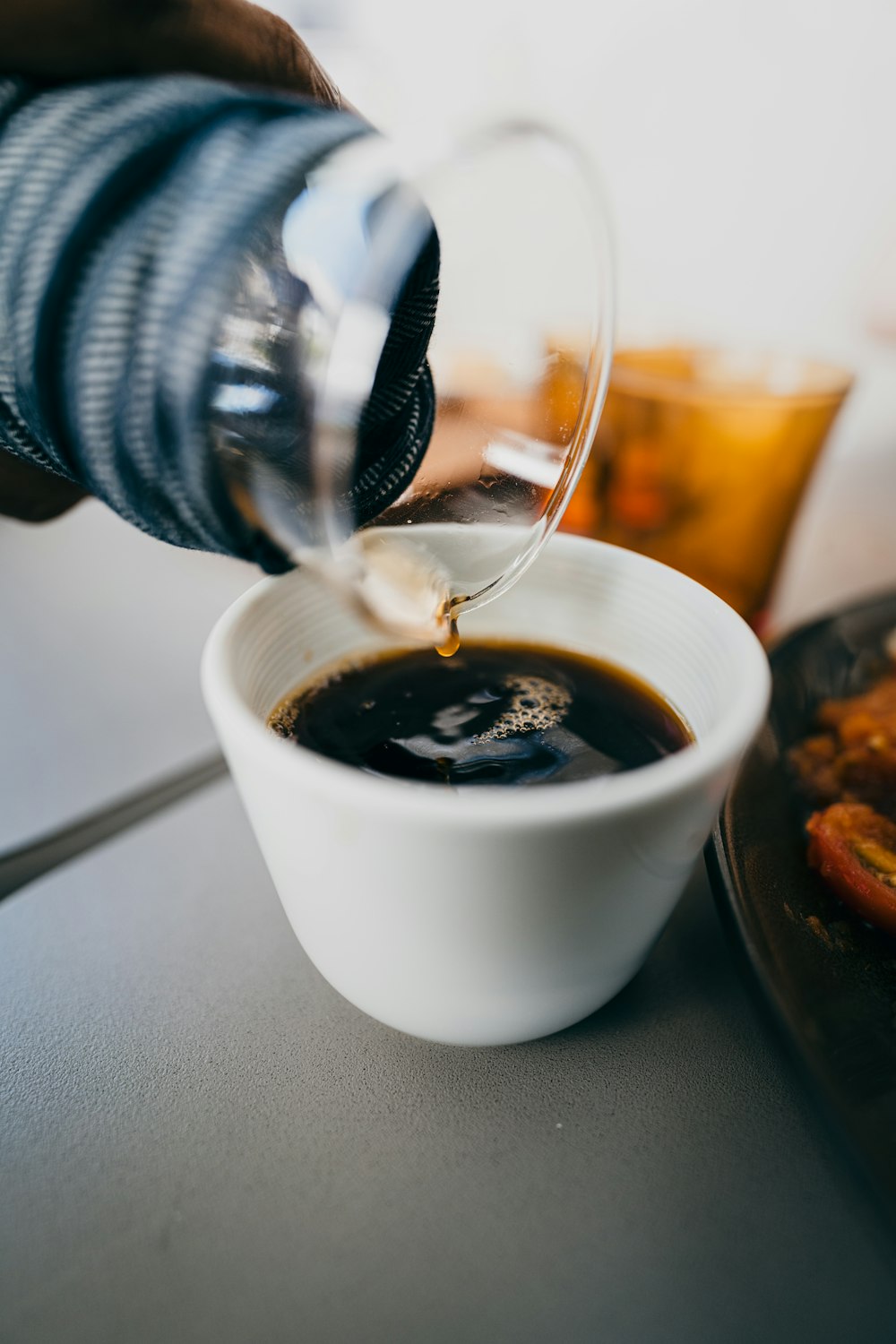 white ceramic cup with black liquid