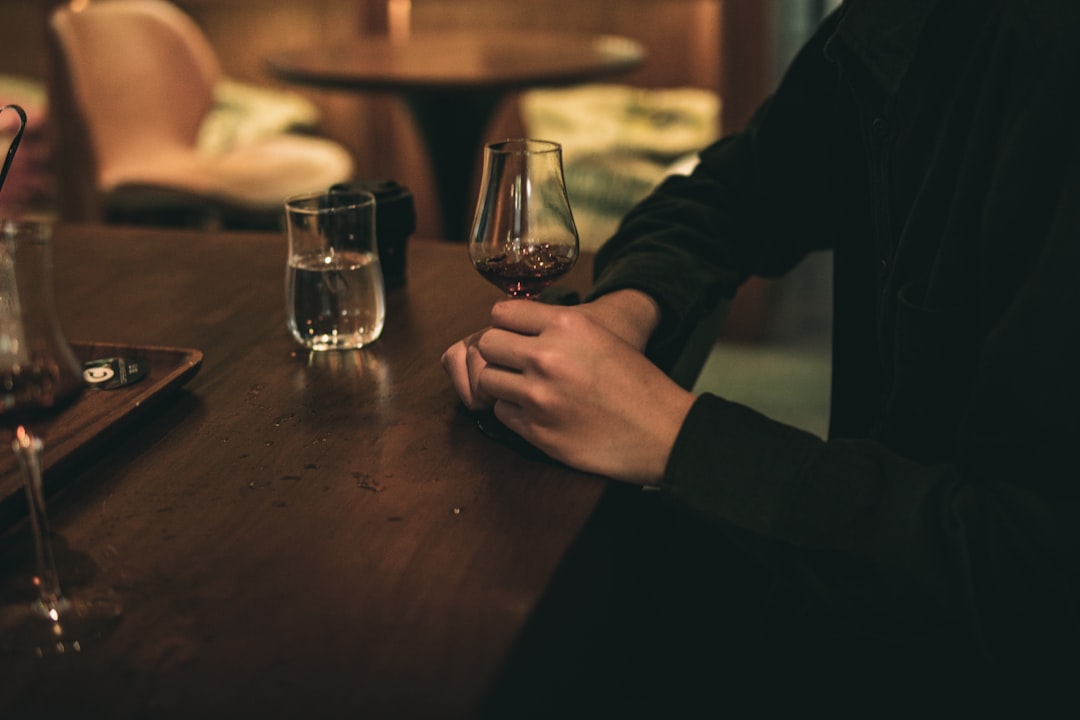 person holding clear drinking glass