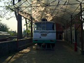 A charming vintage bus waiting to transport guests surrounded by lush greenery.