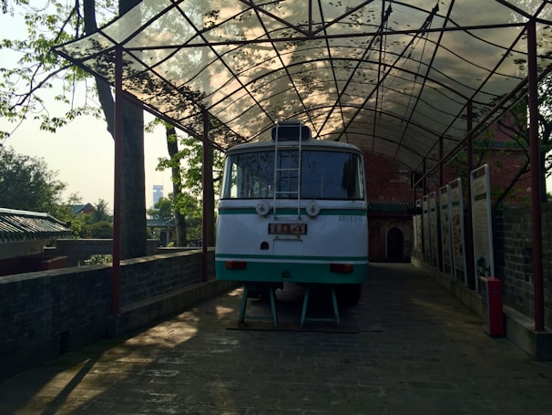 A charming vintage shuttle bus parked outside a sunlit church in Grottammare.