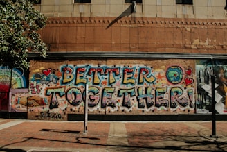 blue and white graffiti on brown concrete building