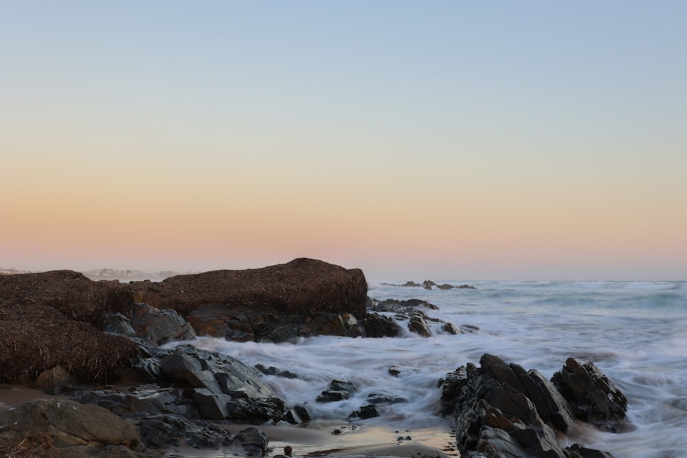 brown rock formation on sea during daytime