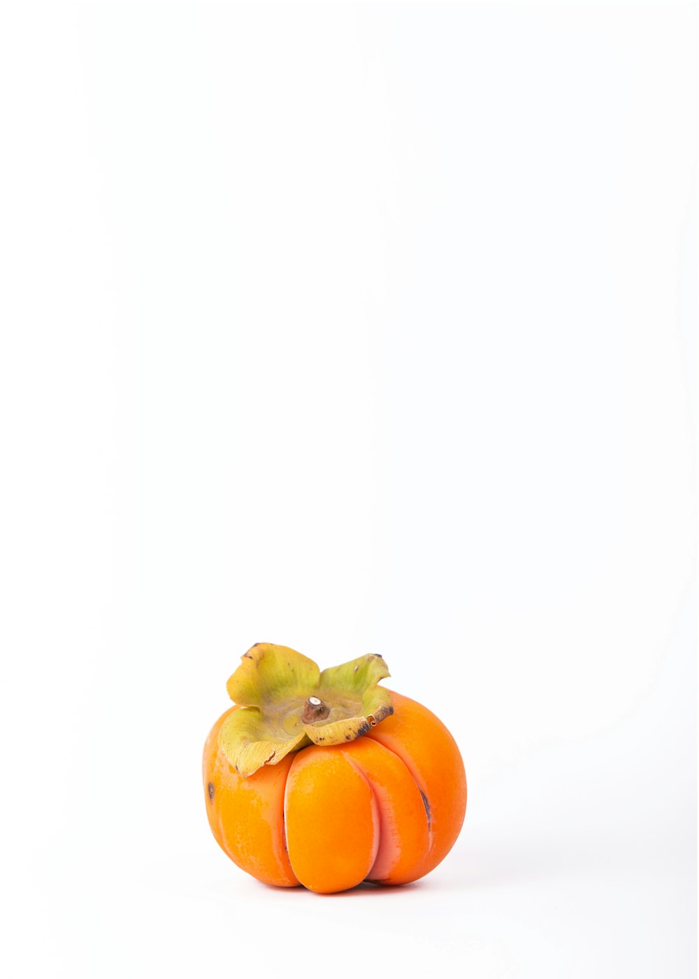 orange tomato on white surface