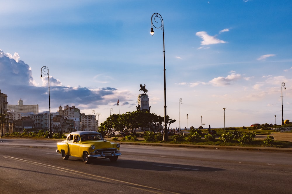 yellow taxi on road during daytime