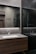 Sleek bathroom vanity with polished countertops and stylish fixtures under warm lighting.