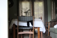 A dining area with a handcrafted wooden table and matching chairs.