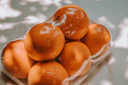 orange fruits on white plastic pack