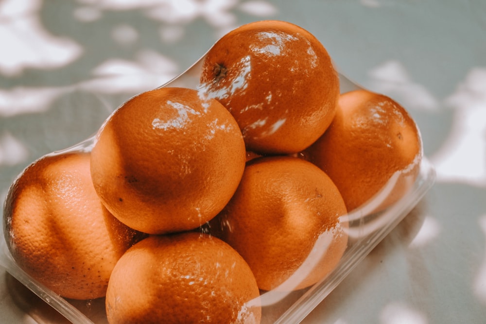 orange fruits on white plastic pack