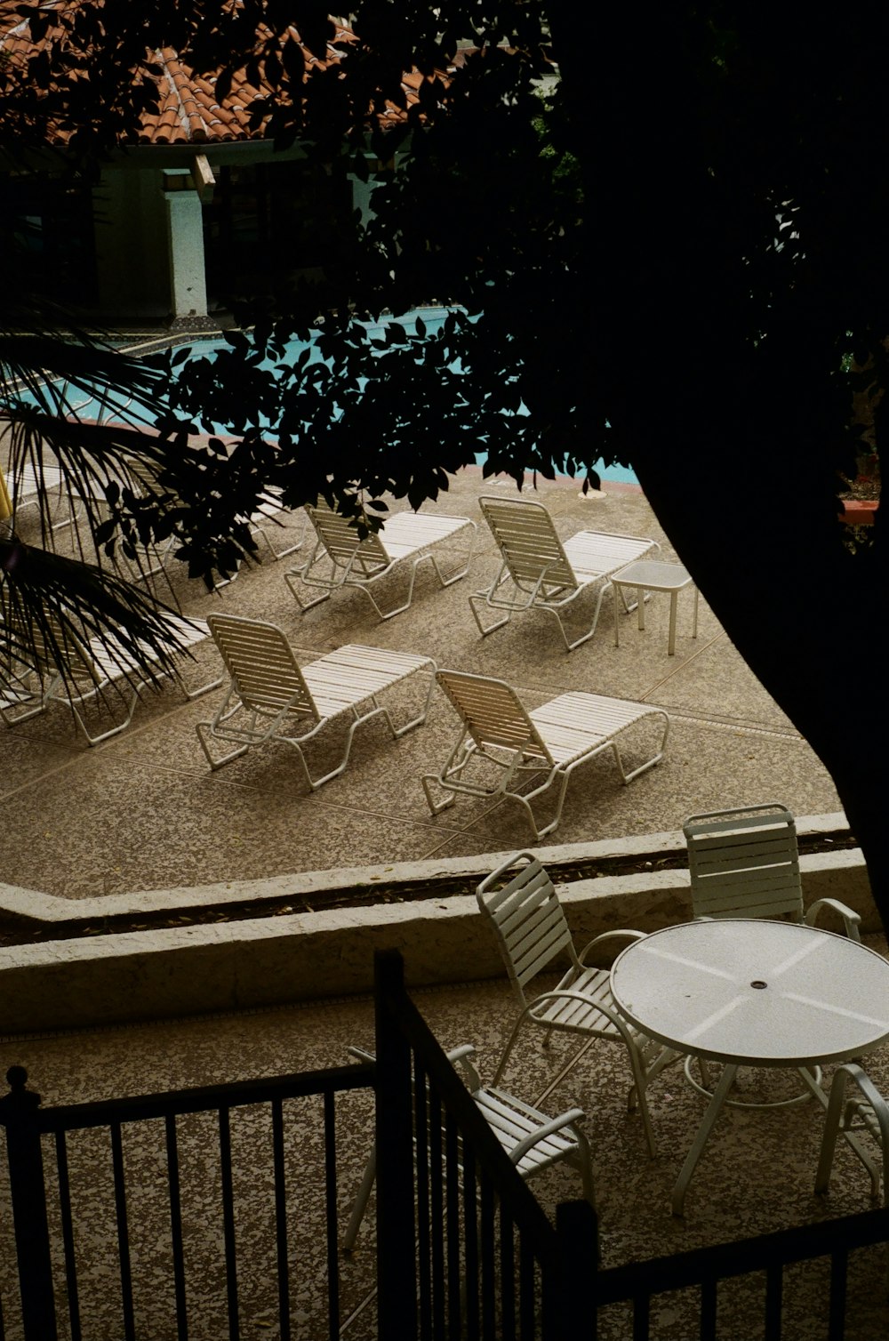 grayscale photo of round table with chairs