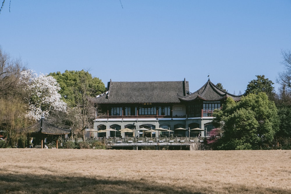 brown and white concrete building near green trees under blue sky during daytime