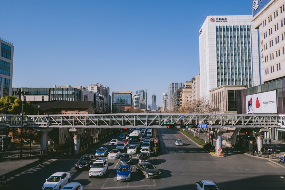 cars parked on parking lot near bridge during daytime