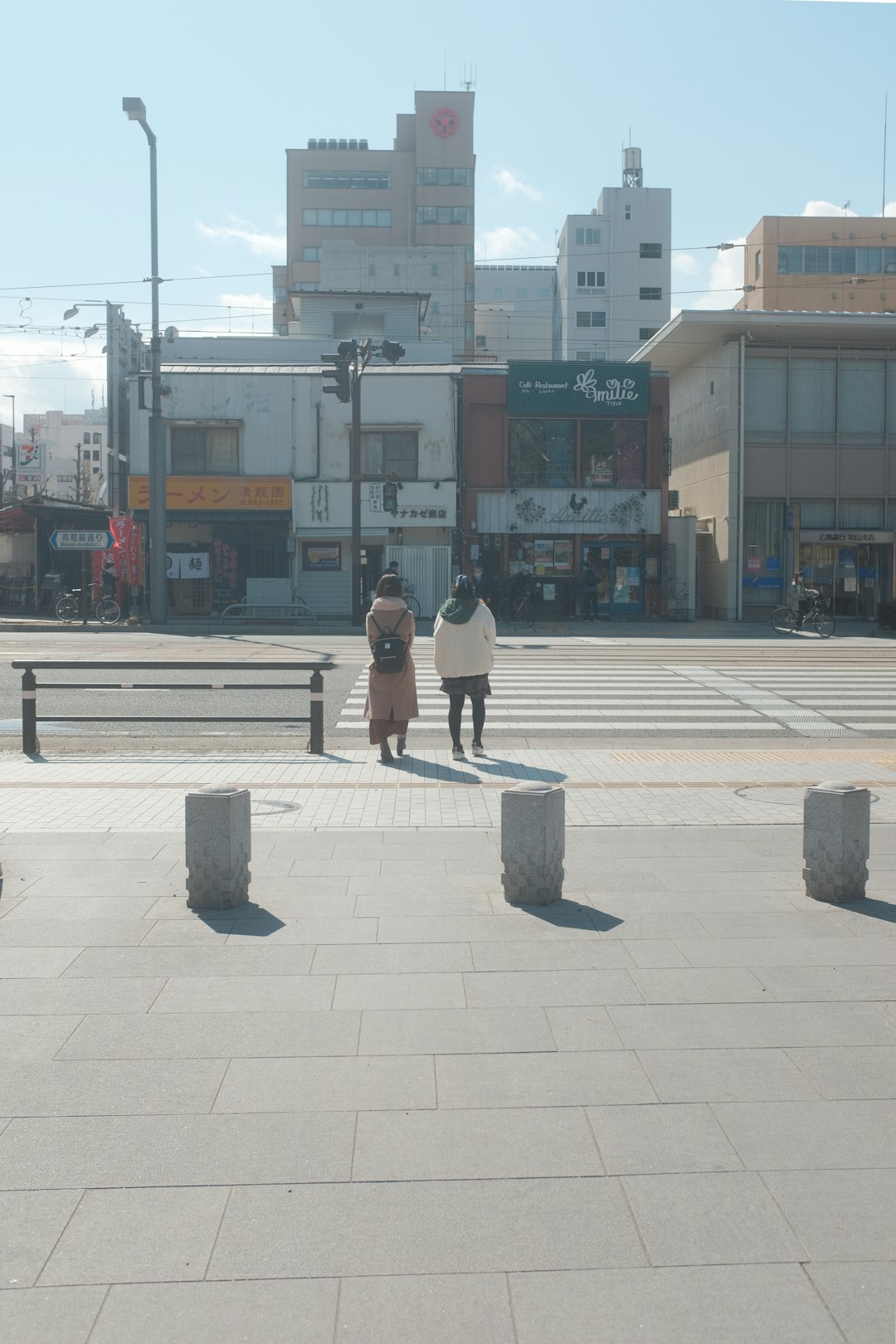 woman in black jacket and black pants walking on sidewalk during daytime