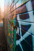A close-up of colorful street art on a brick wall.