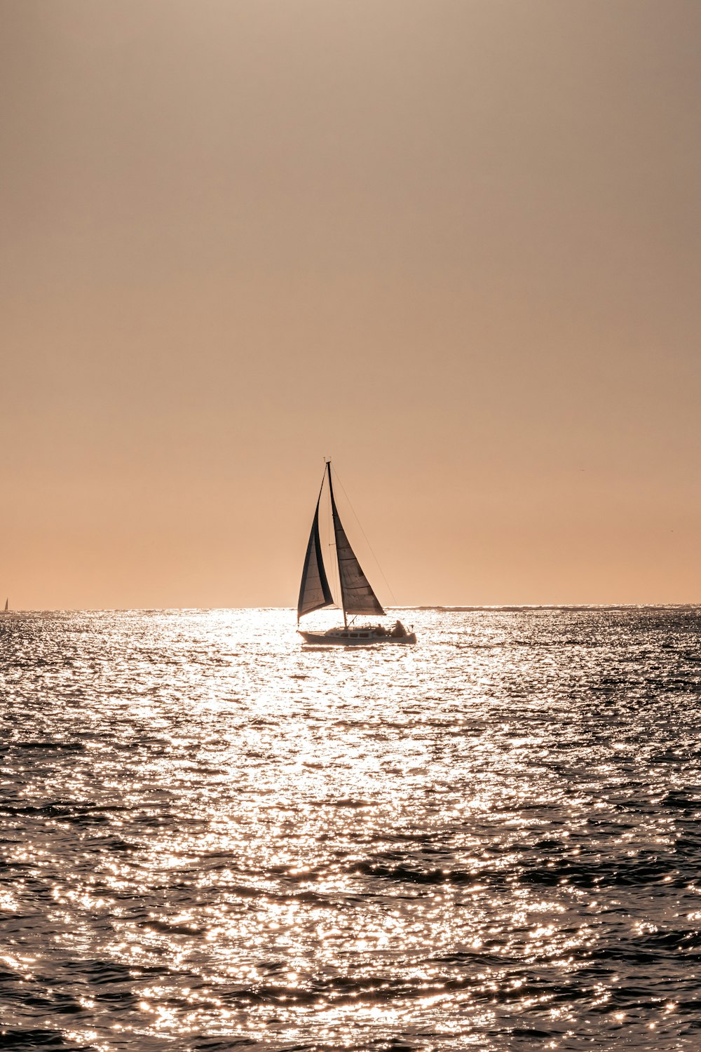 sailboat on sea during sunset