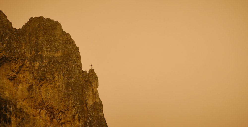 brown rock formation under white sky during daytime