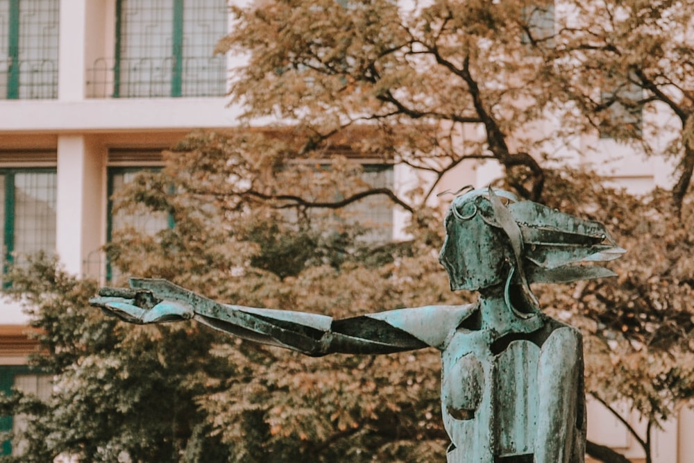 man holding a book statue