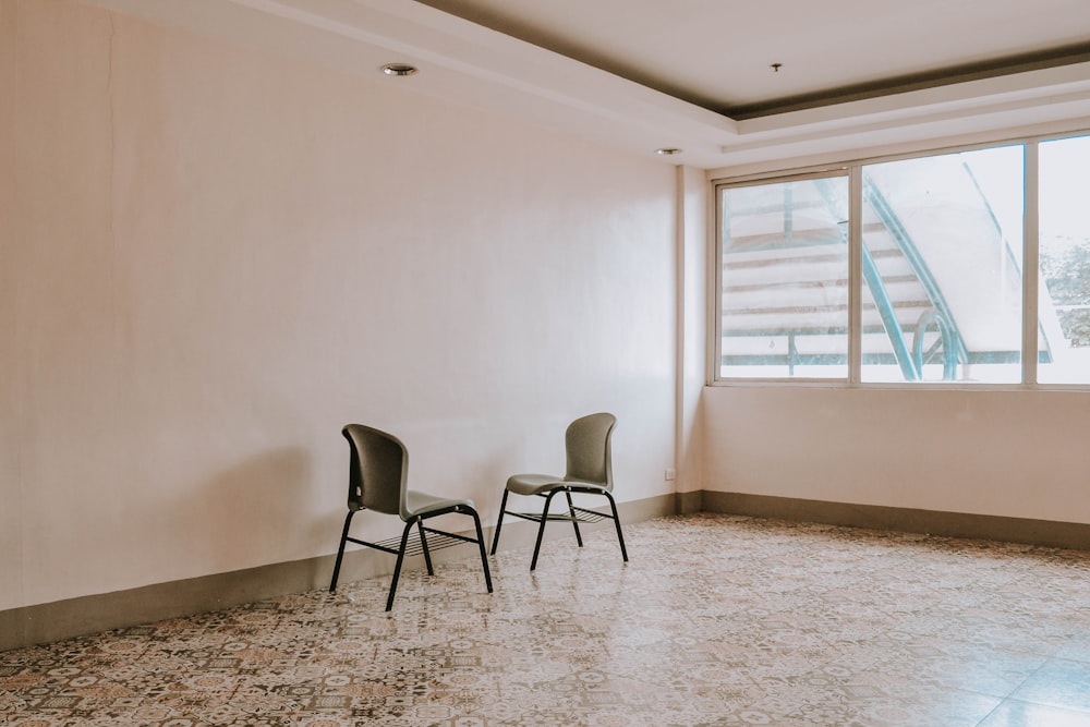 black metal framed gray padded chairs