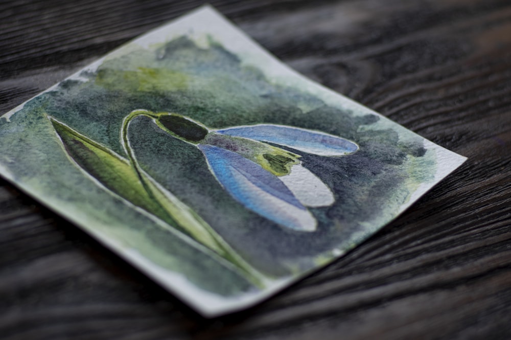 green and blue leaf on brown wooden table