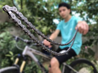 Close-up of a shiny bike chain freshly oiled during a maintenance service.