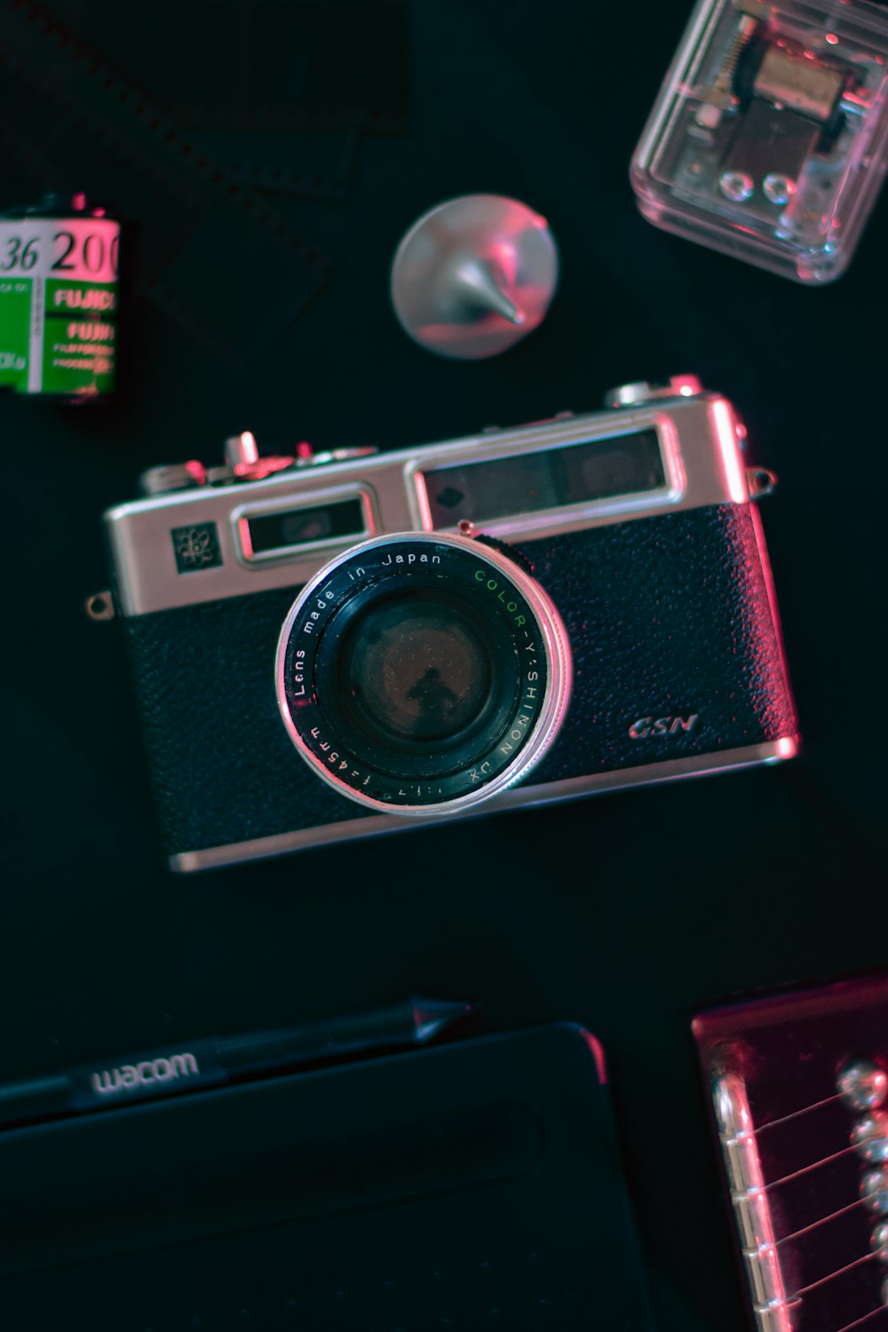 black and silver camera on black table