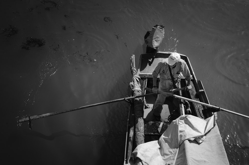 man in black and white suit on boat