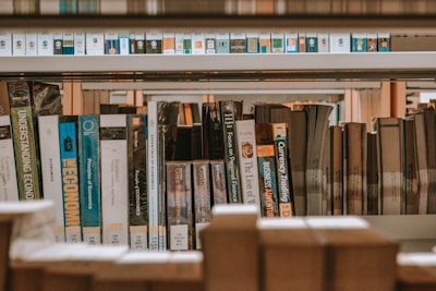 books on brown wooden shelf