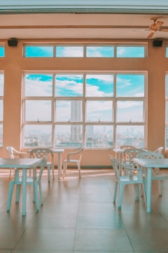 Bright conference room with glass walls and a panoramic city view.