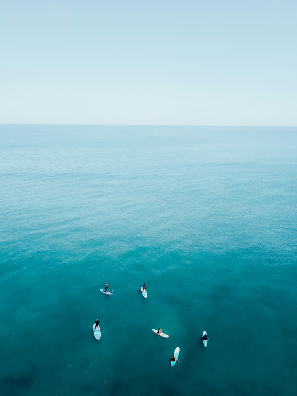 people swimming in the sea during daytime