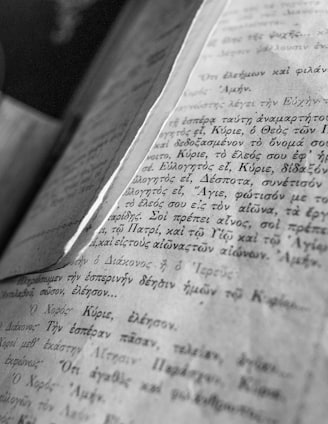 opened book on brown wooden table