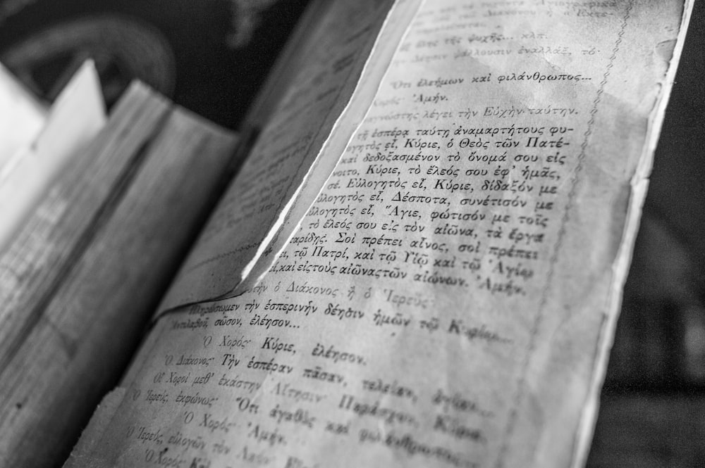 opened book on brown wooden table