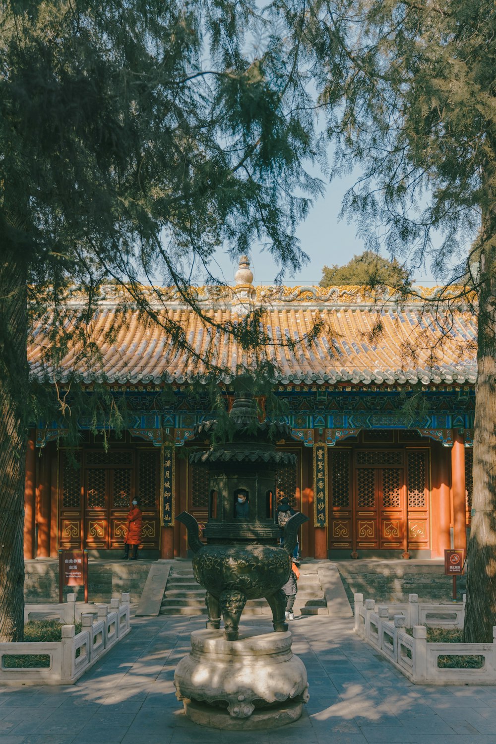 a courtyard with a fountain surrounded by trees