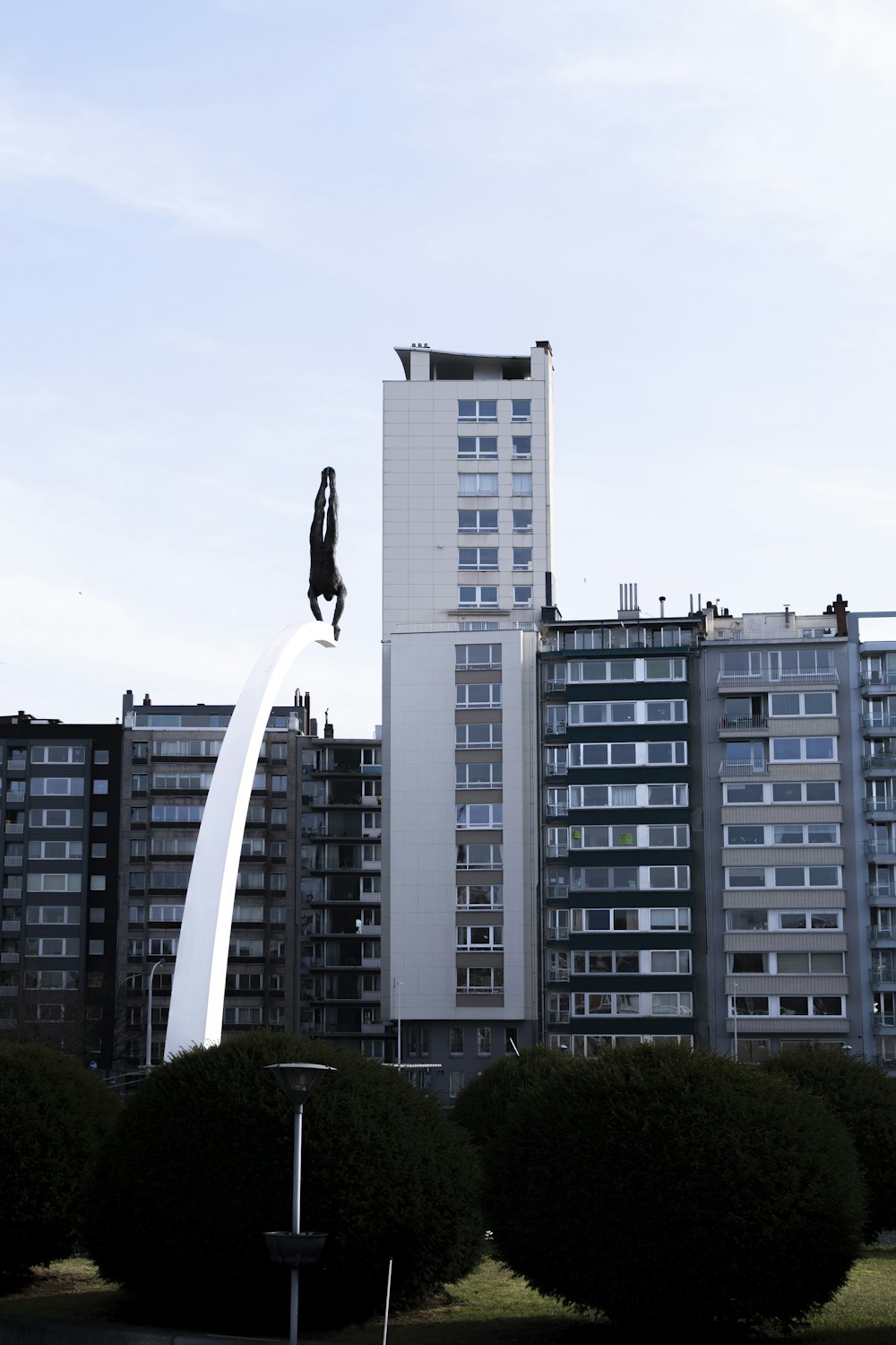 white concrete building near green trees during daytime