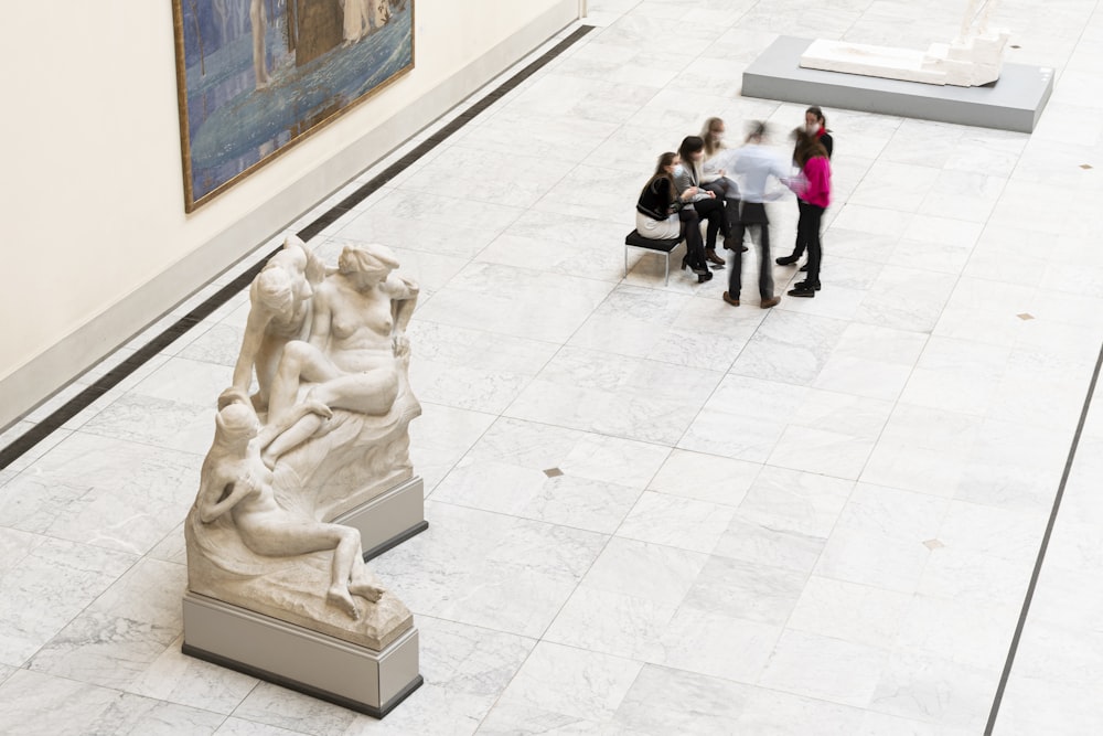 people walking on white tiled floor