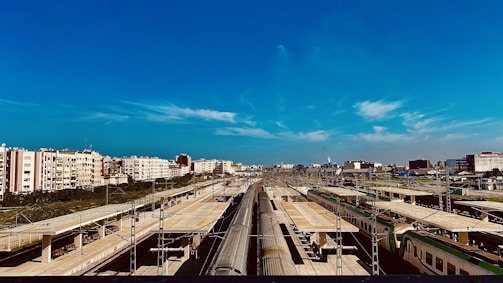 A panoramic view of a completed government infrastructure project with smooth roads and railway lines.