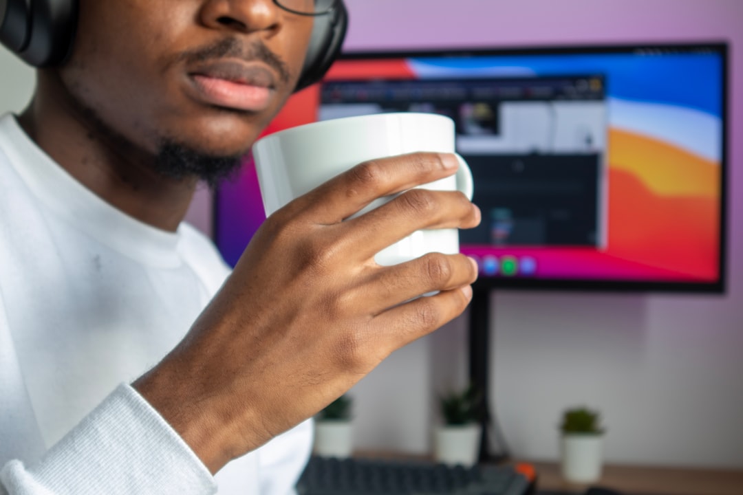 man in white dress shirt holding white cup