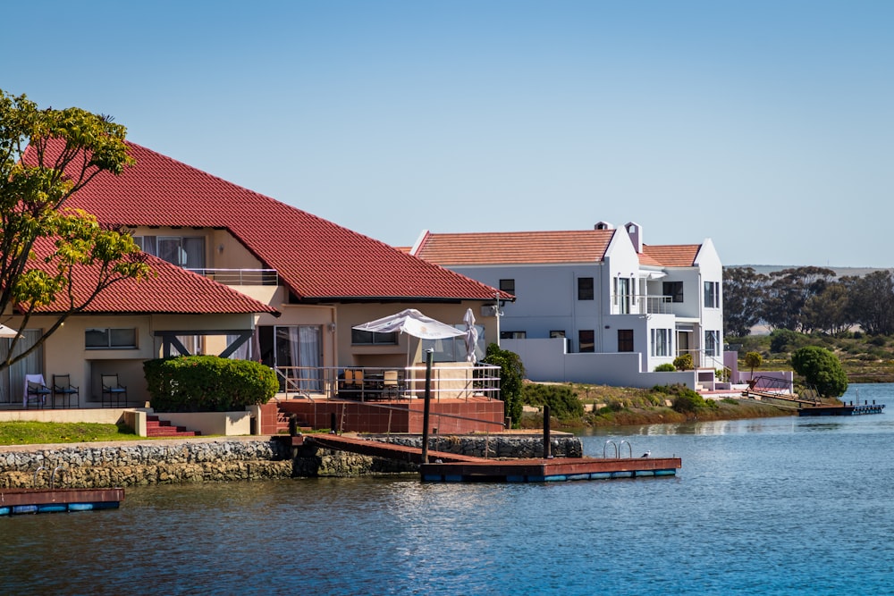 brown boat on body of water near houses during daytime