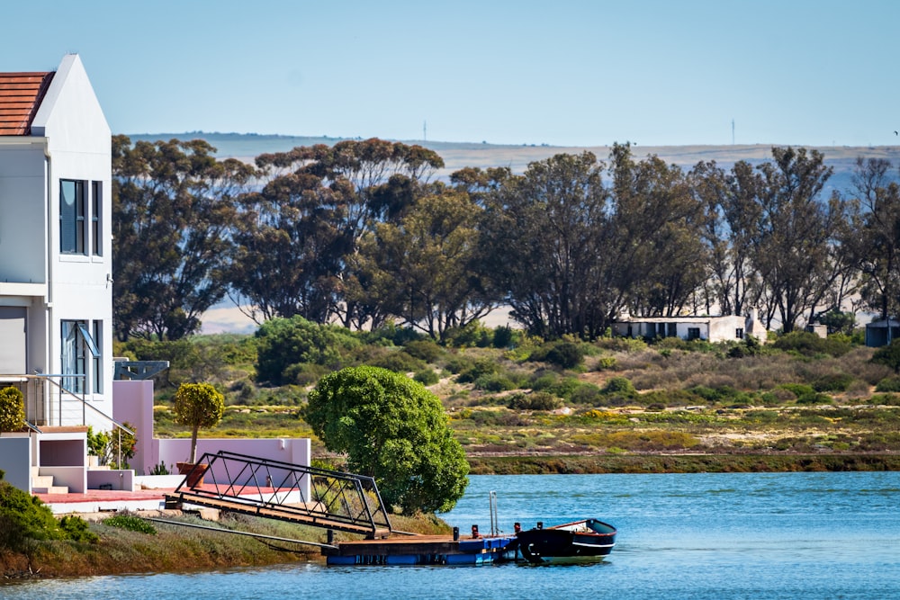 boat on dock near trees during daytime